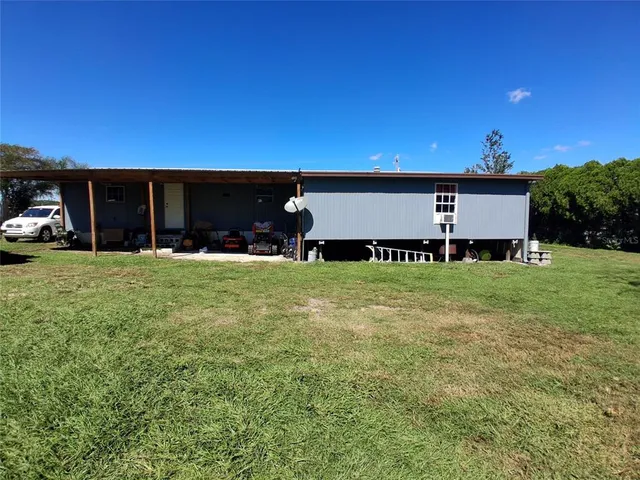 a view of a house with yard and a car park fire pit