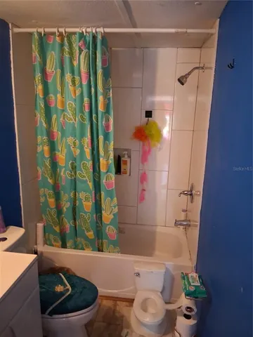 a bathroom with a sink and a shower curtain