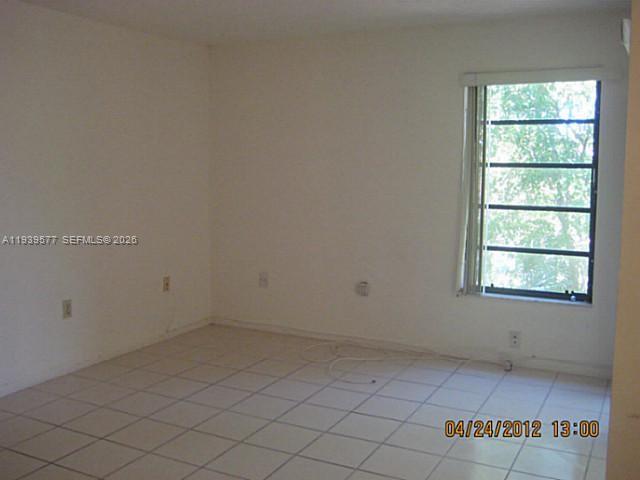 9015 Southwest 125th Avenue, Unit N406 Miami, FL 33186 - Photo 14 of 24 an empty room with a window