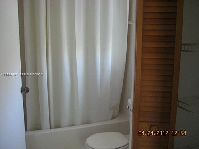 9015 Southwest 125th Avenue, Unit N406 Miami, FL 33186 - Photo 8 of 24 a bathroom with a shower curtain