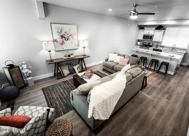 a living room with furniture kitchen view and a table