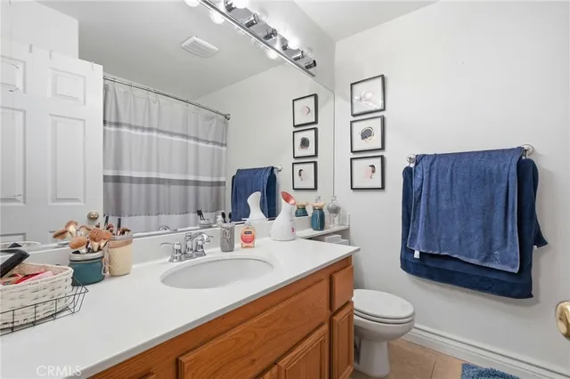 a bathroom with a sink vanity mirror and toilet