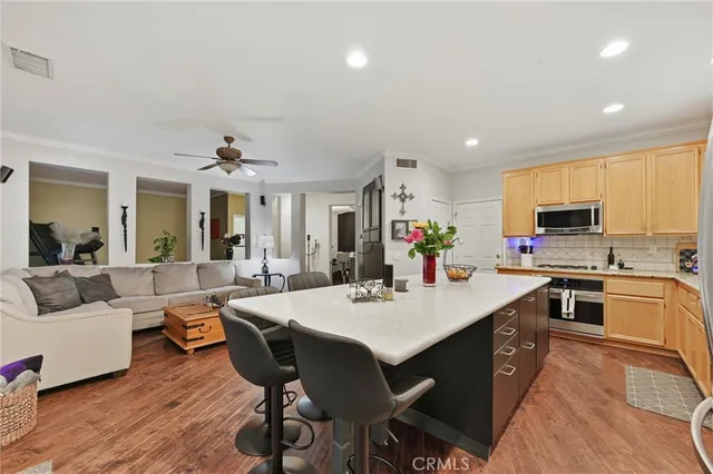 a large kitchen with kitchen island a sink table and chairs