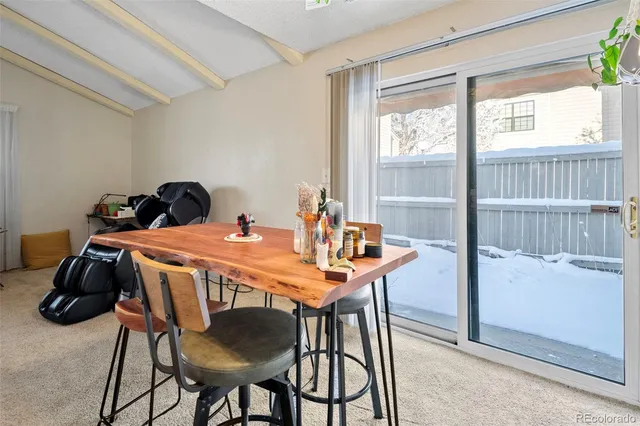 a dining room with furniture and window
