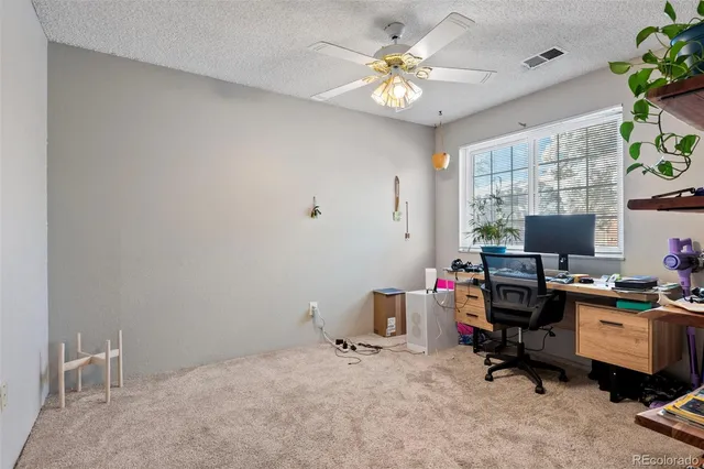a view of a workspace with furniture and a window