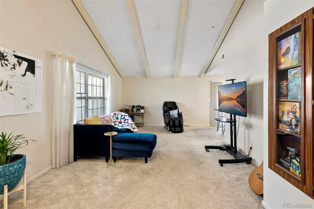 a living room with furniture gym equipment and a large window