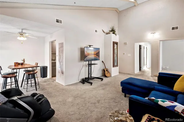 a view of a livingroom with furniture and a gym equipment
