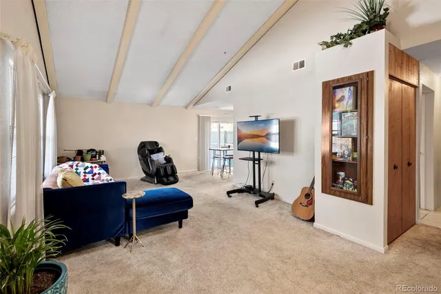 a living room with furniture gym equipment and a flat screen tv