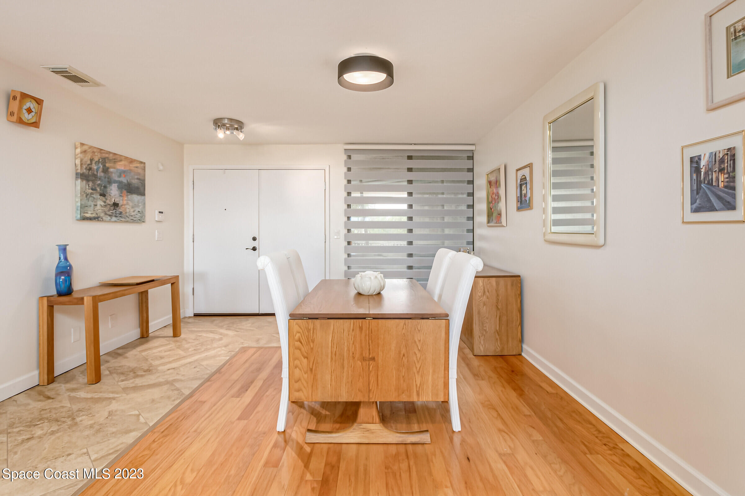 700 Wave Crest Avenue, Unit 202 Indialantic, FL 32903 - Photo 13 of 29 a view of a dining room with furniture window and wooden floor