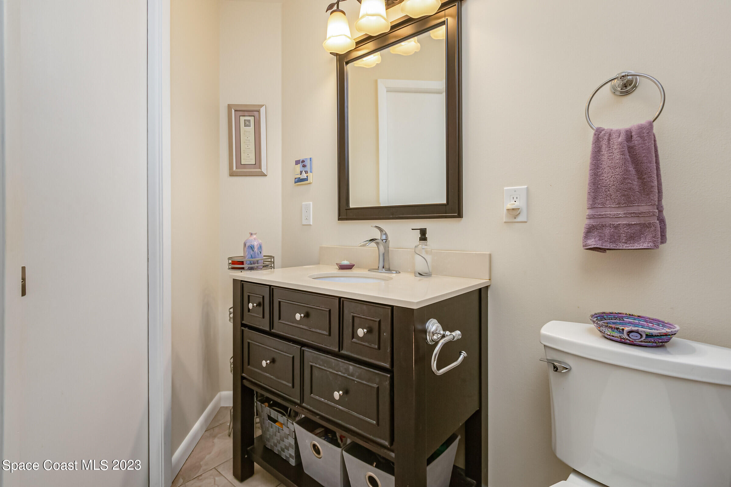 700 Wave Crest Avenue, Unit 202 Indialantic, FL 32903 - Photo 17 of 29 a bathroom with a sink vanity and a mirror