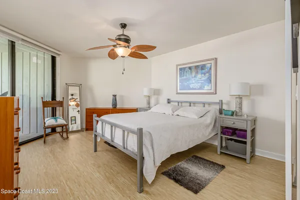 a bed room with a bed and a chandelier