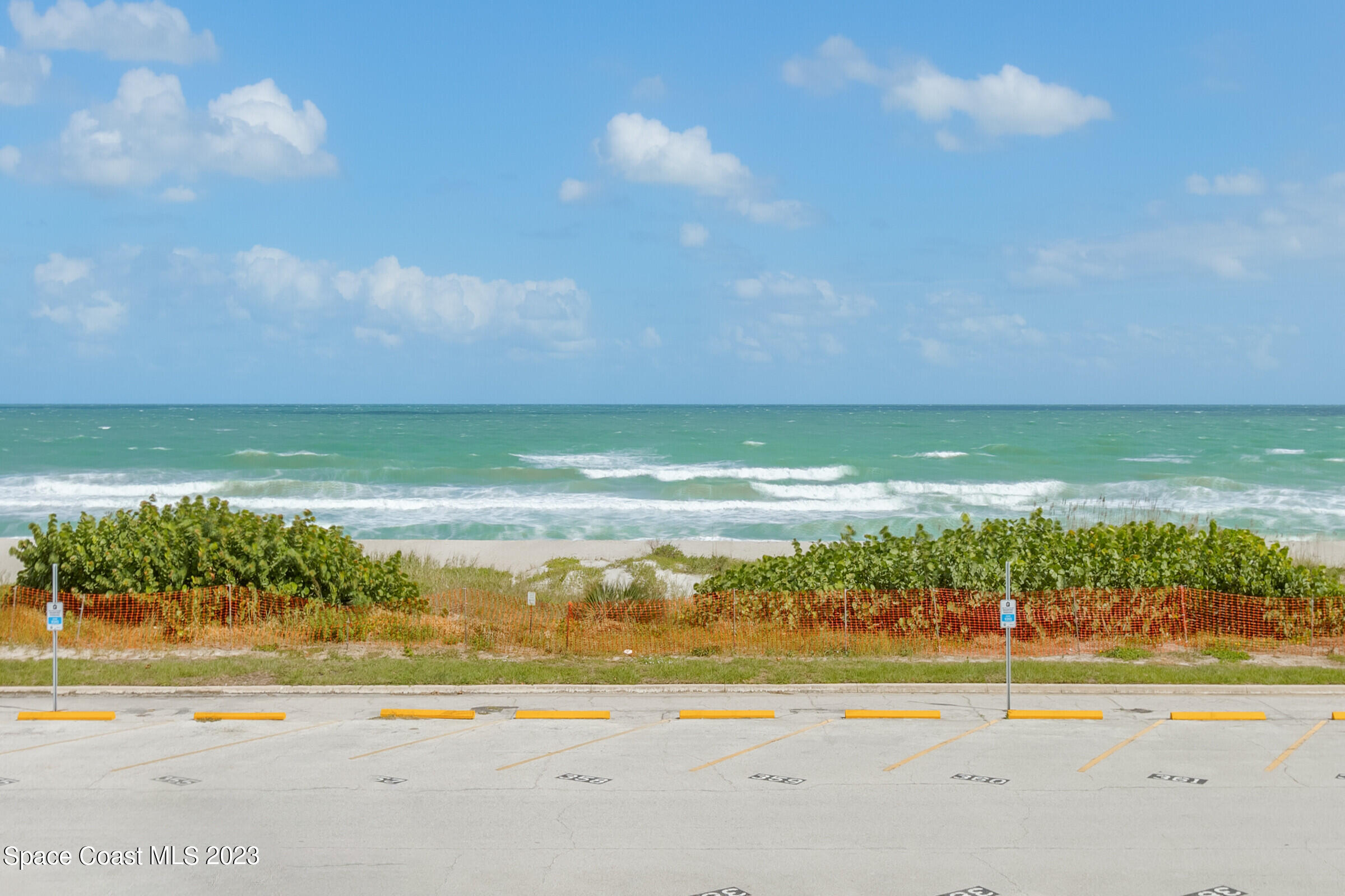 700 Wave Crest Avenue, Unit 202 Indialantic, FL 32903 - Photo 27 of 29 a view of an ocean and beach
