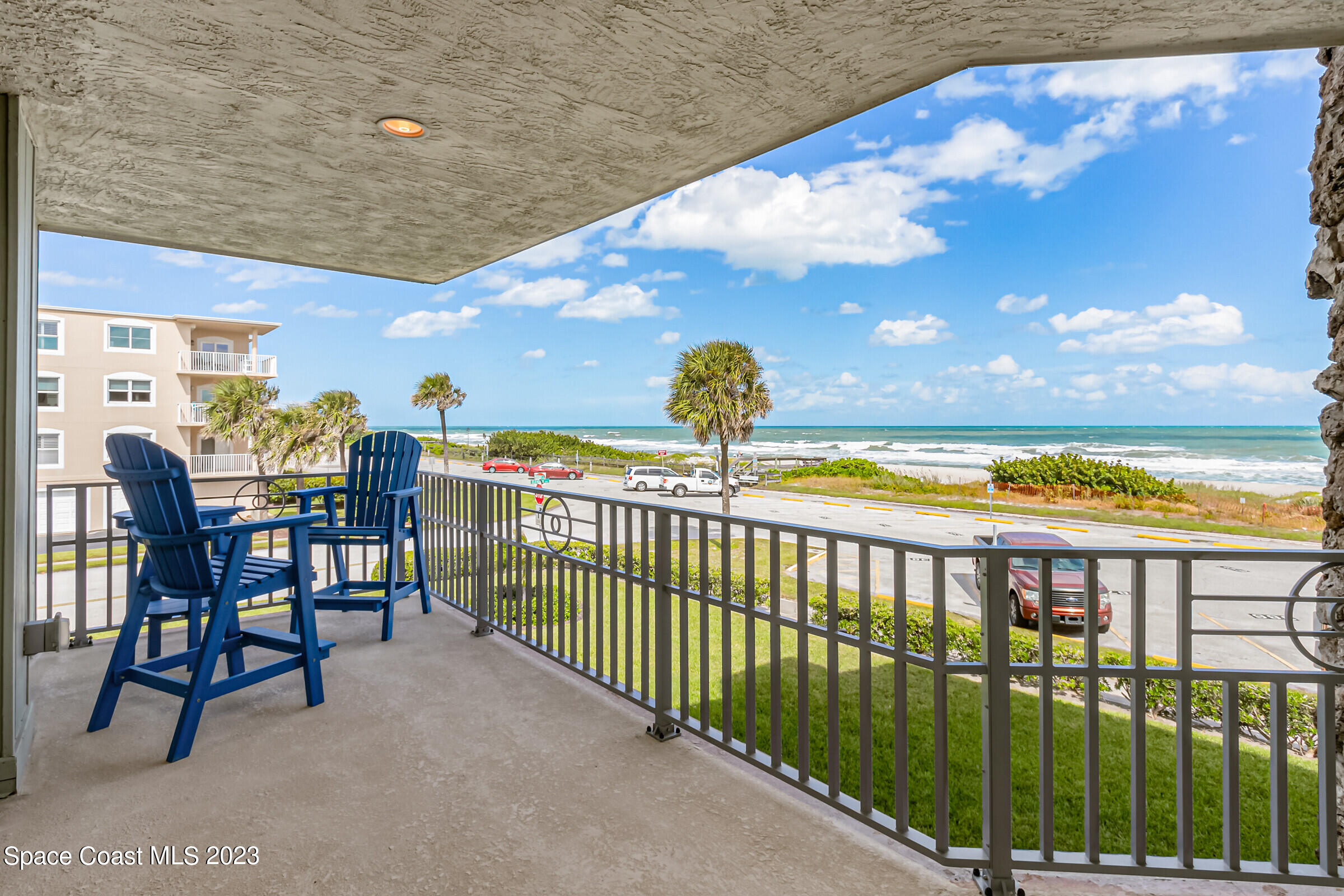 700 Wave Crest Avenue, Unit 202 Indialantic, FL 32903 - Photo 5 of 29 a view of a chairs and table in the balcony