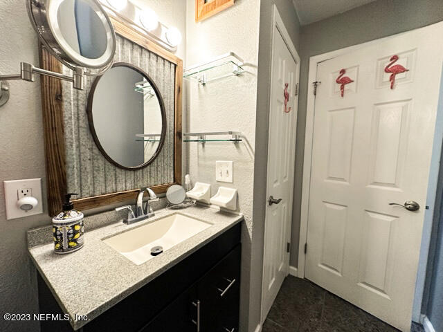 1504 Raiford Road Starke, FL 32091 - Photo 12 of 24 a bathroom with a sink vanity granite and a mirror