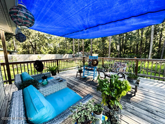 1504 Raiford Road Starke, FL 32091 - Photo 14 of 24 a view of a patio with lawn chairs potted plants with wooden floor
