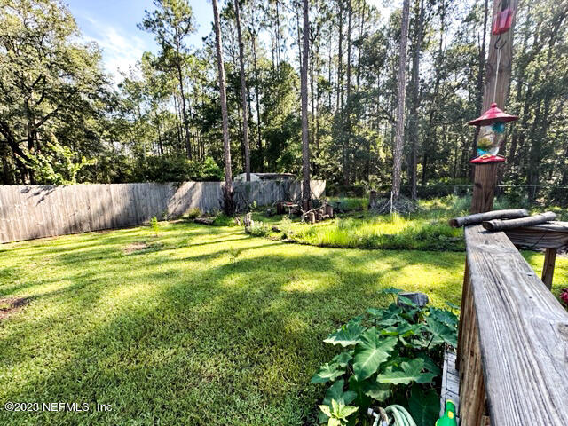 1504 Raiford Road Starke, FL 32091 - Photo 17 of 24 a view of swimming pool with a garden and trees
