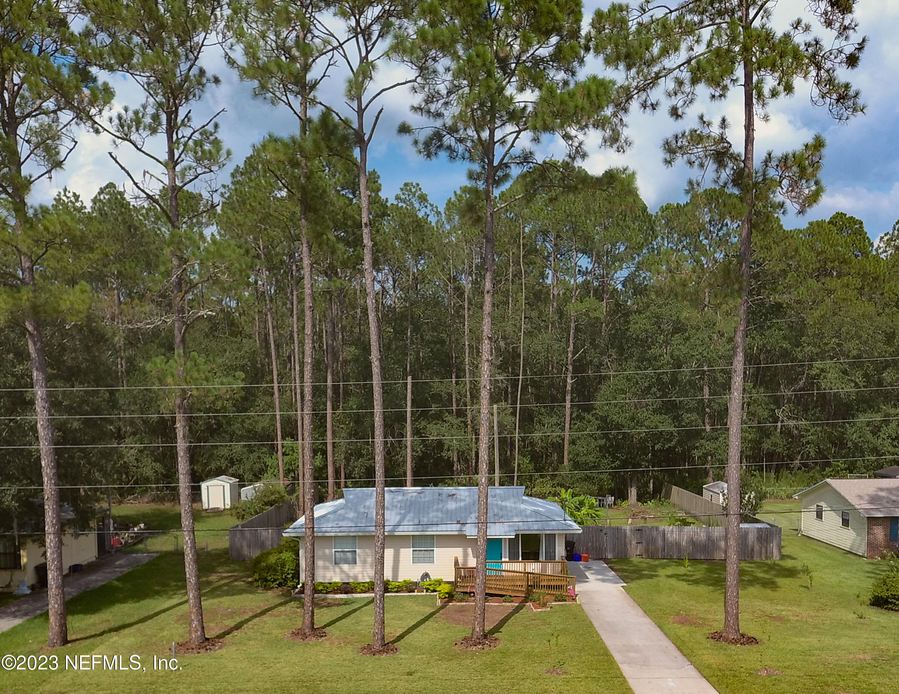 1504 Raiford Road Starke, FL 32091 - Photo 24 of 24 a view of a chair and tables in the patio next to a yard