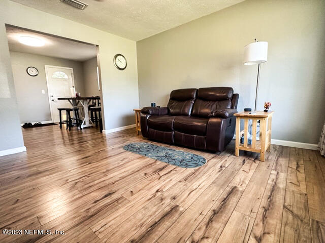 1504 Raiford Road Starke, FL 32091 - Photo 3 of 24 a living room with furniture and a wooden floor