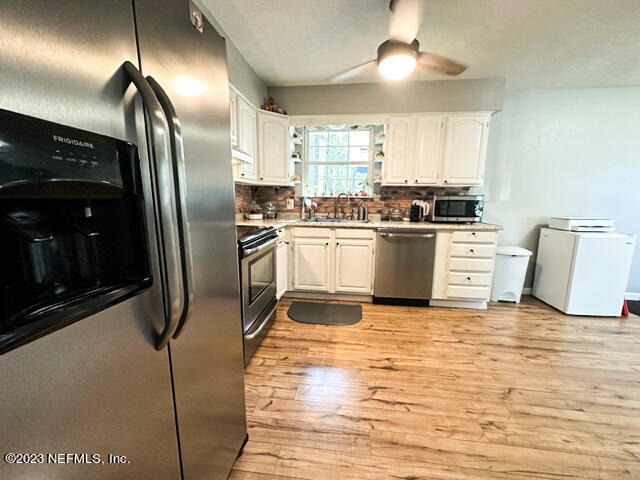 1504 Raiford Road Starke, FL 32091 - Photo 8 of 24 a kitchen with stainless steel appliances granite countertop a refrigerator a stove a sink and a refrigerator