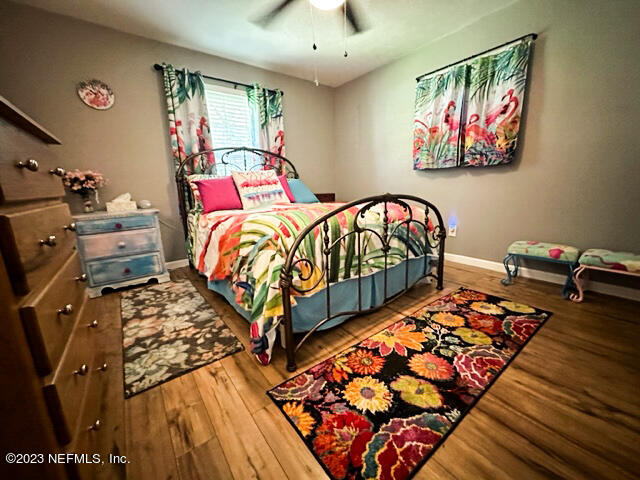 1504 Raiford Road Starke, FL 32091 - Photo 10 of 24 a bedroom with a bed and wooden floor