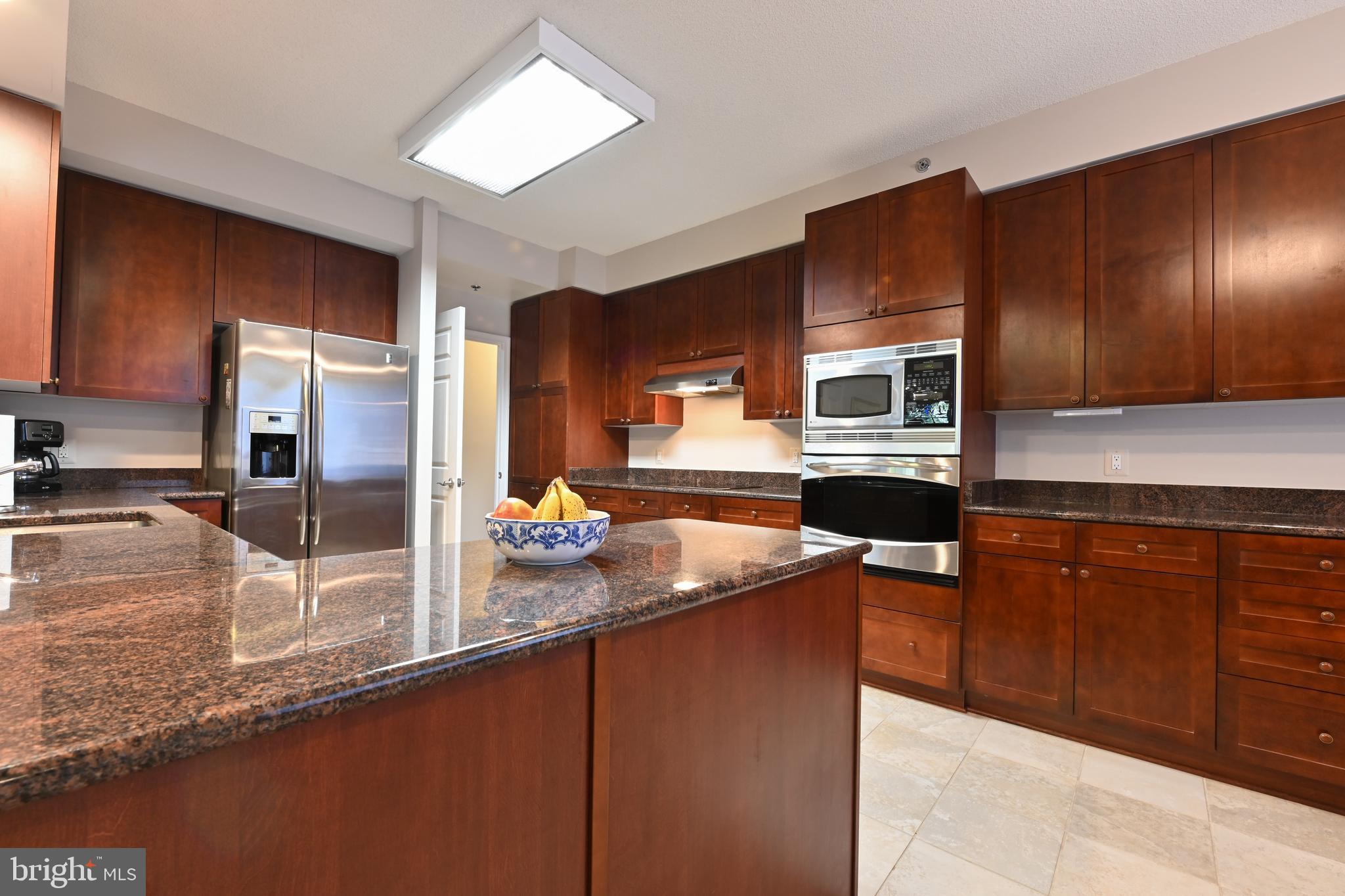 a kitchen with stainless steel appliances granite countertop a sink a stove counter space and cabinets