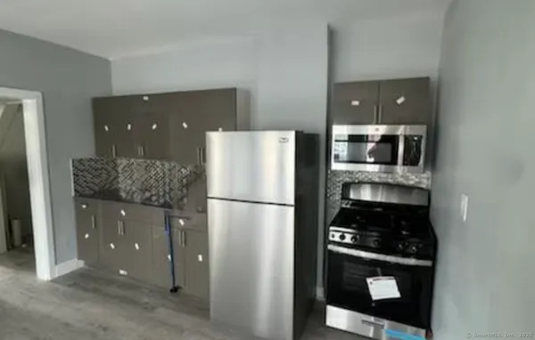 a kitchen with a refrigerator and cabinets