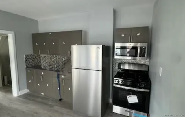 a kitchen with a refrigerator and cabinets