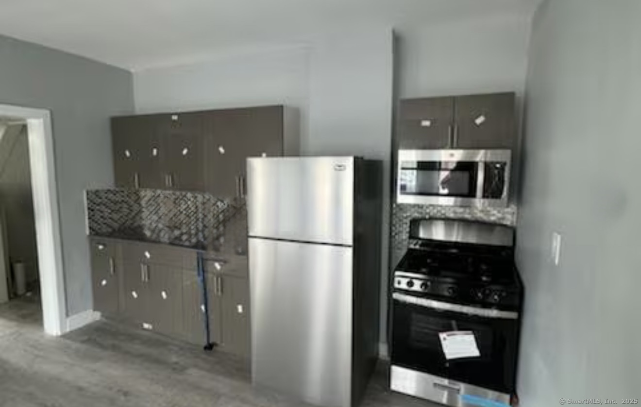 a kitchen with a refrigerator and cabinets