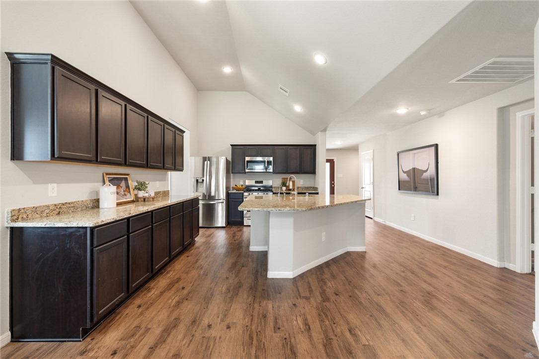 2018 Eagle View Drive Navasota, TX 77868 - Photo 8 of 28 a large kitchen with wooden floors stainless steel appliances and cabinets