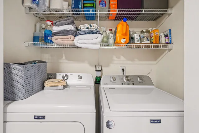 a utility room with dryer washer and shoe rack