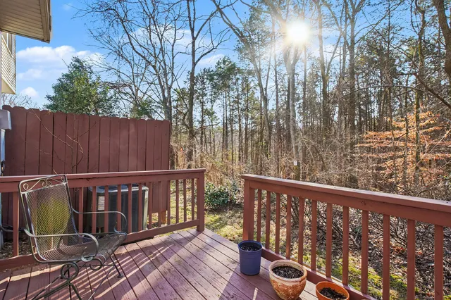a view of a balcony with wooden floor and fence