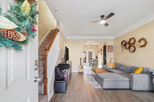 a living room with furniture and wooden floor