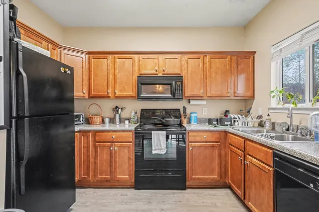 a kitchen with stainless steel appliances granite countertop a stove a sink dishwasher and a refrigerator