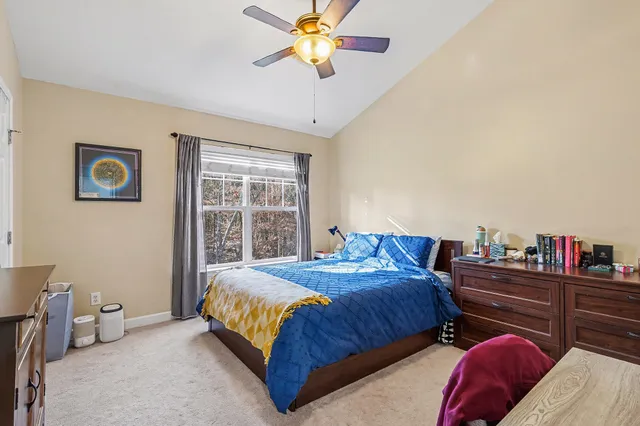 a bedroom with bed and a chandelier