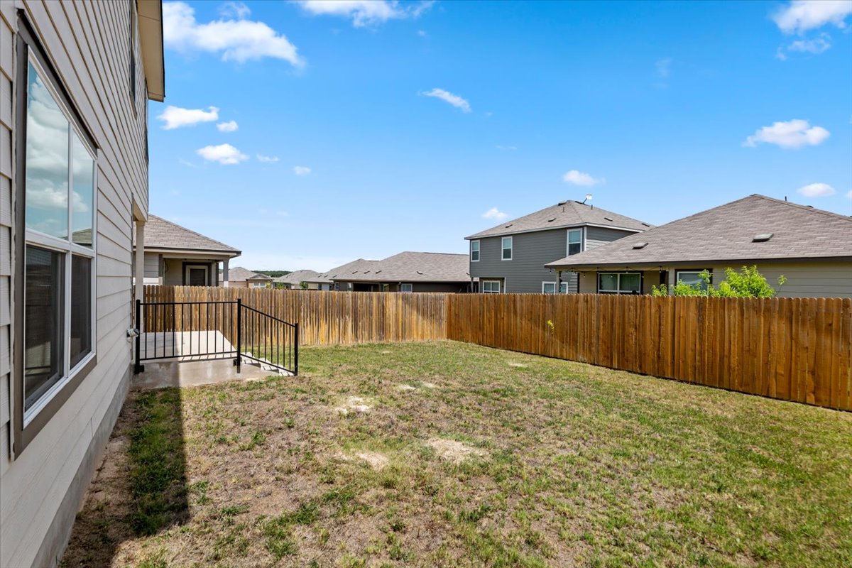 448 Perfect World Loop Jarrell, TX 76537 - Photo 8 of 40 Secure backyard space offers a private fence and concrete patio.