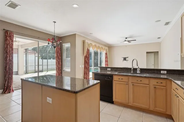 a kitchen with granite countertop a sink and cabinets