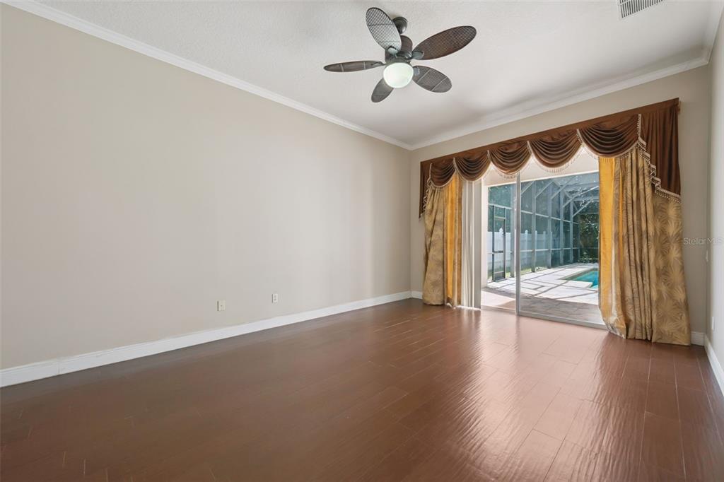 11450 Arborside Bend Way Windermere, FL 34786 - Photo 20 of 50 an empty room with wooden floor and windows