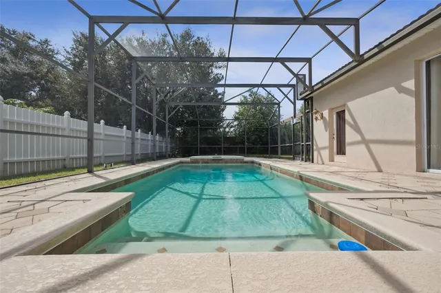 a view of a backyard with a swimming pool