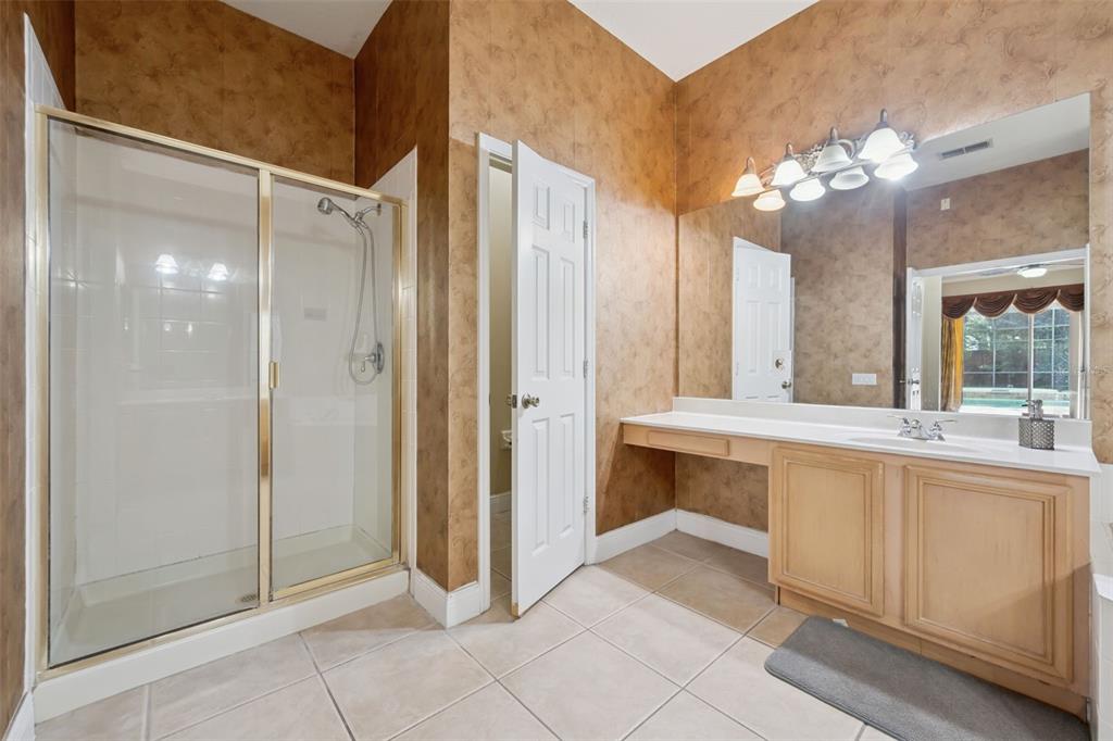 11450 Arborside Bend Way Windermere, FL 34786 - Photo 23 of 50 a spacious bathroom with a mirror sink and vanity