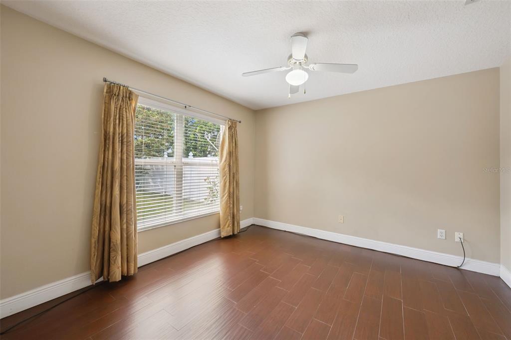11450 Arborside Bend Way Windermere, FL 34786 - Photo 27 of 50 an empty room with wooden floor fan and windows