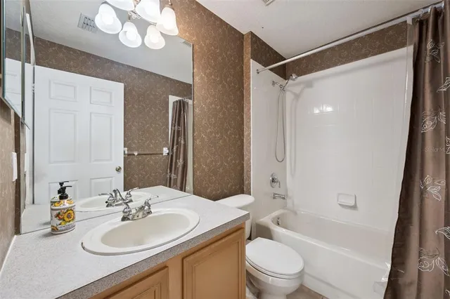 a bathroom with a sink toilet tub and shower