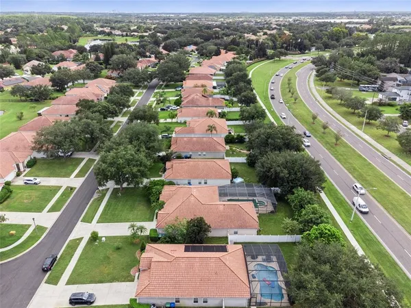 an aerial view of residential houses with outdoor space and river