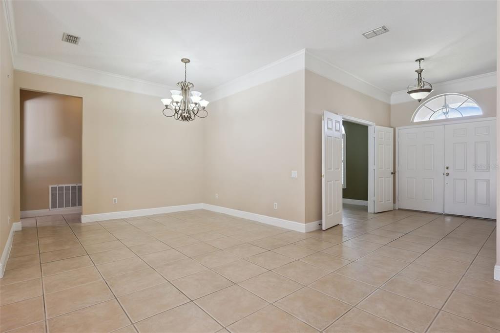 11450 Arborside Bend Way Windermere, FL 34786 - Photo 4 of 50 an empty room with chandelier and glass door