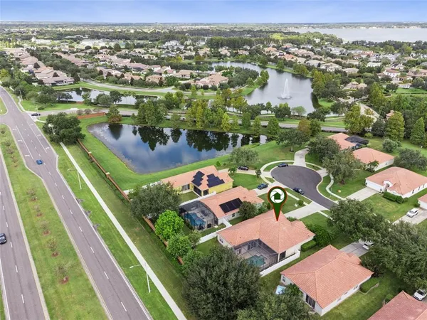 an aerial view of residential houses with outdoor space and river
