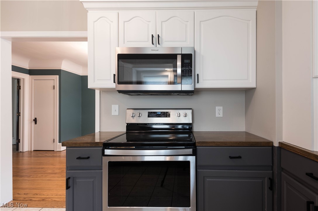 7003 Brecksville Road Independence, OH 44131 - Photo 26 of 35 Kitchen with dark countertops, stainless steel appliances, white cabinets, and gray cabinetry