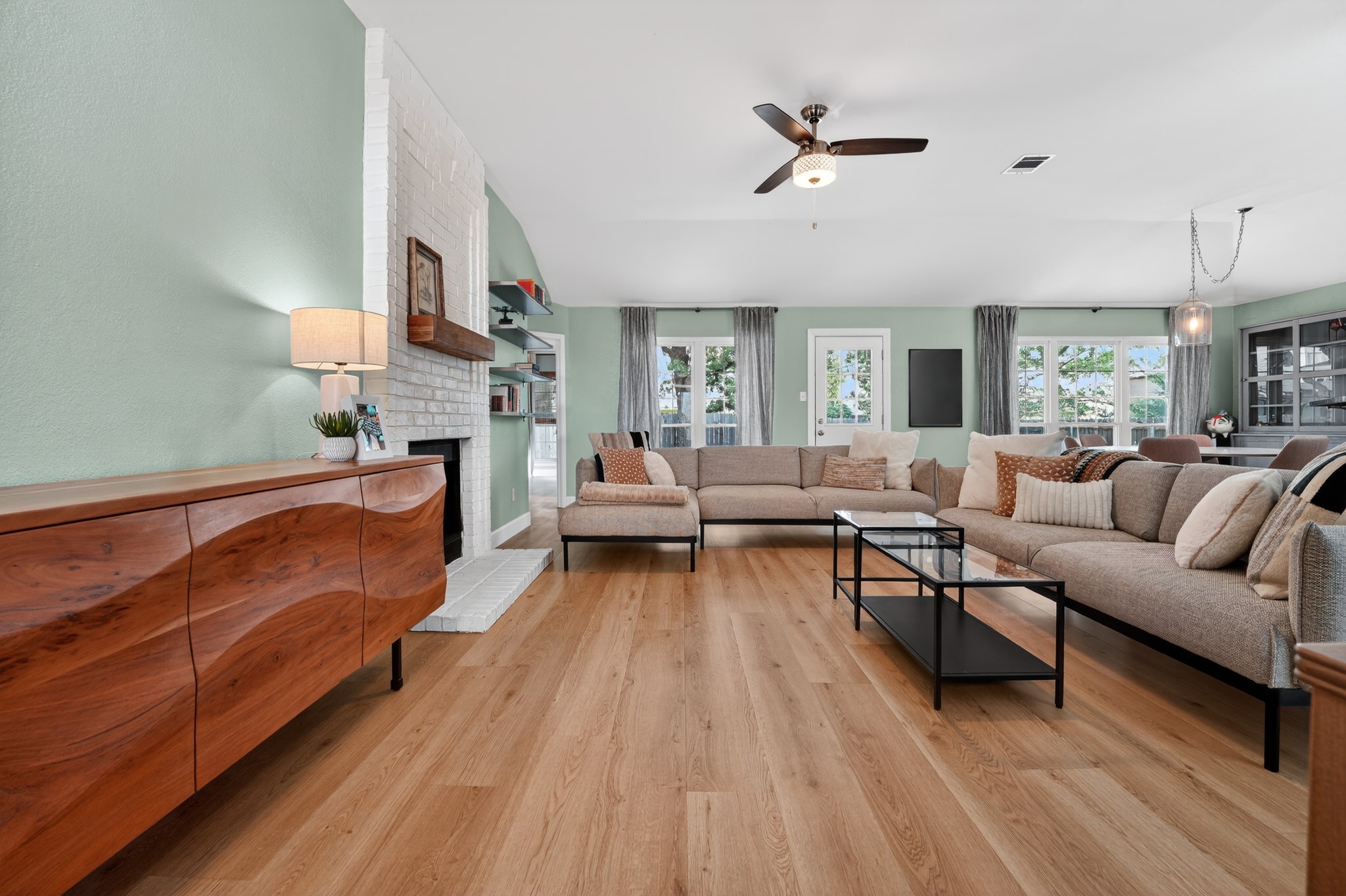 1811 Old Mill Road Cedar Park, TX 78613 - Photo 5 of 39 Bright hardwood floors and a modern brick fireplace anchor this spacious, well-lit living area.