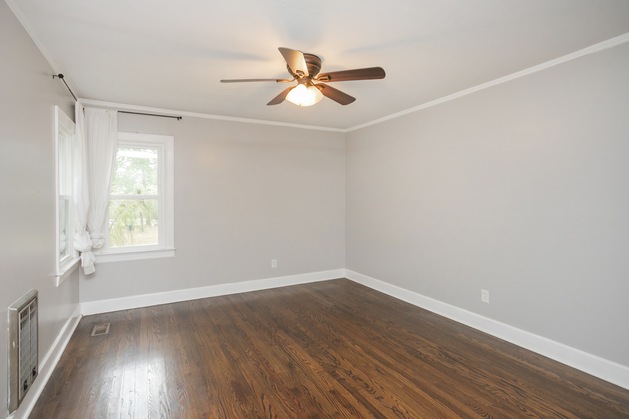 105 Echo Road Dickson, TN 37055 - Photo 14 of 32 an empty room with wooden floor fan and windows