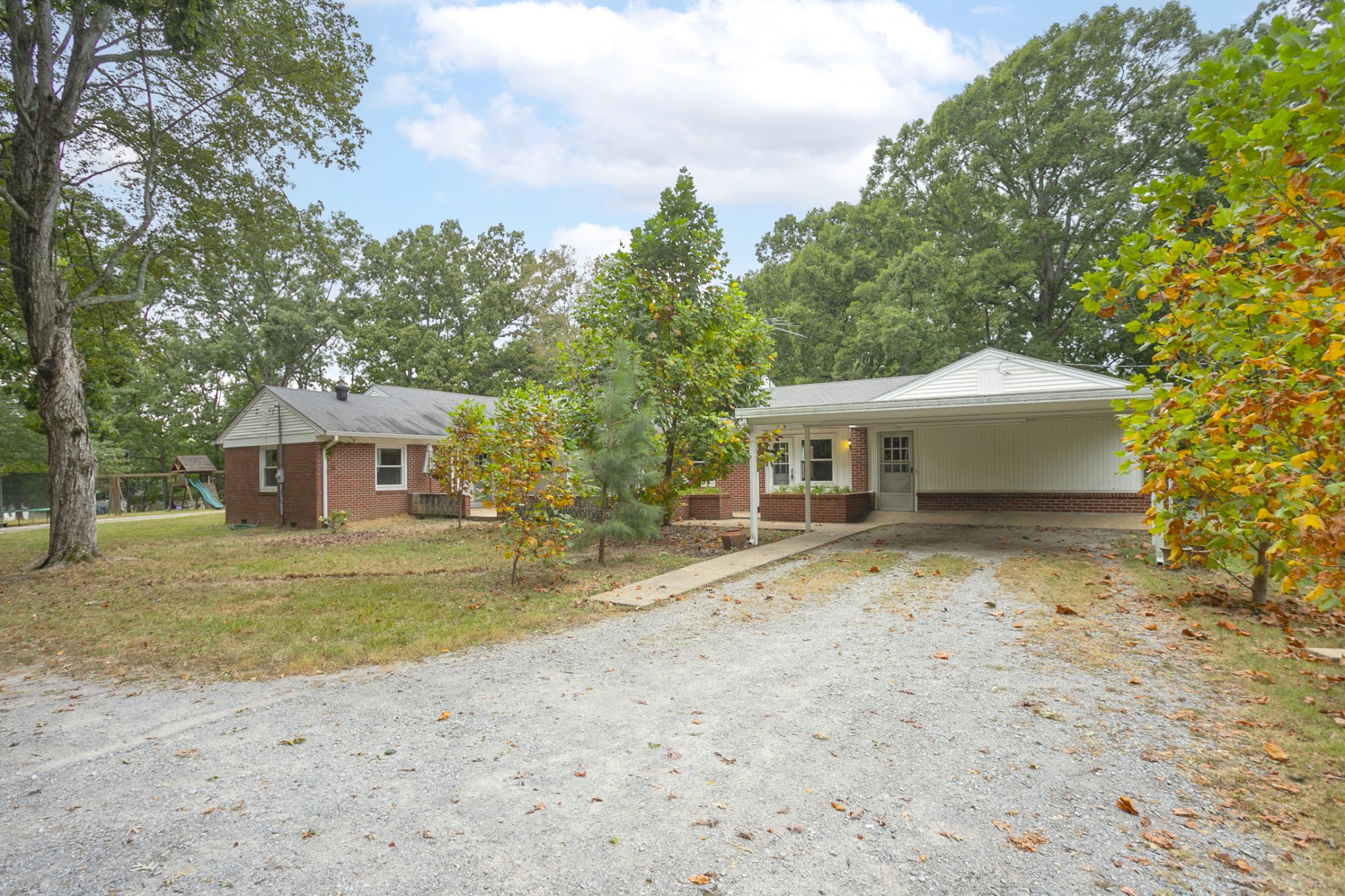 105 Echo Road Dickson, TN 37055 - Photo 23 of 32 a front view of a house with a garden and trees