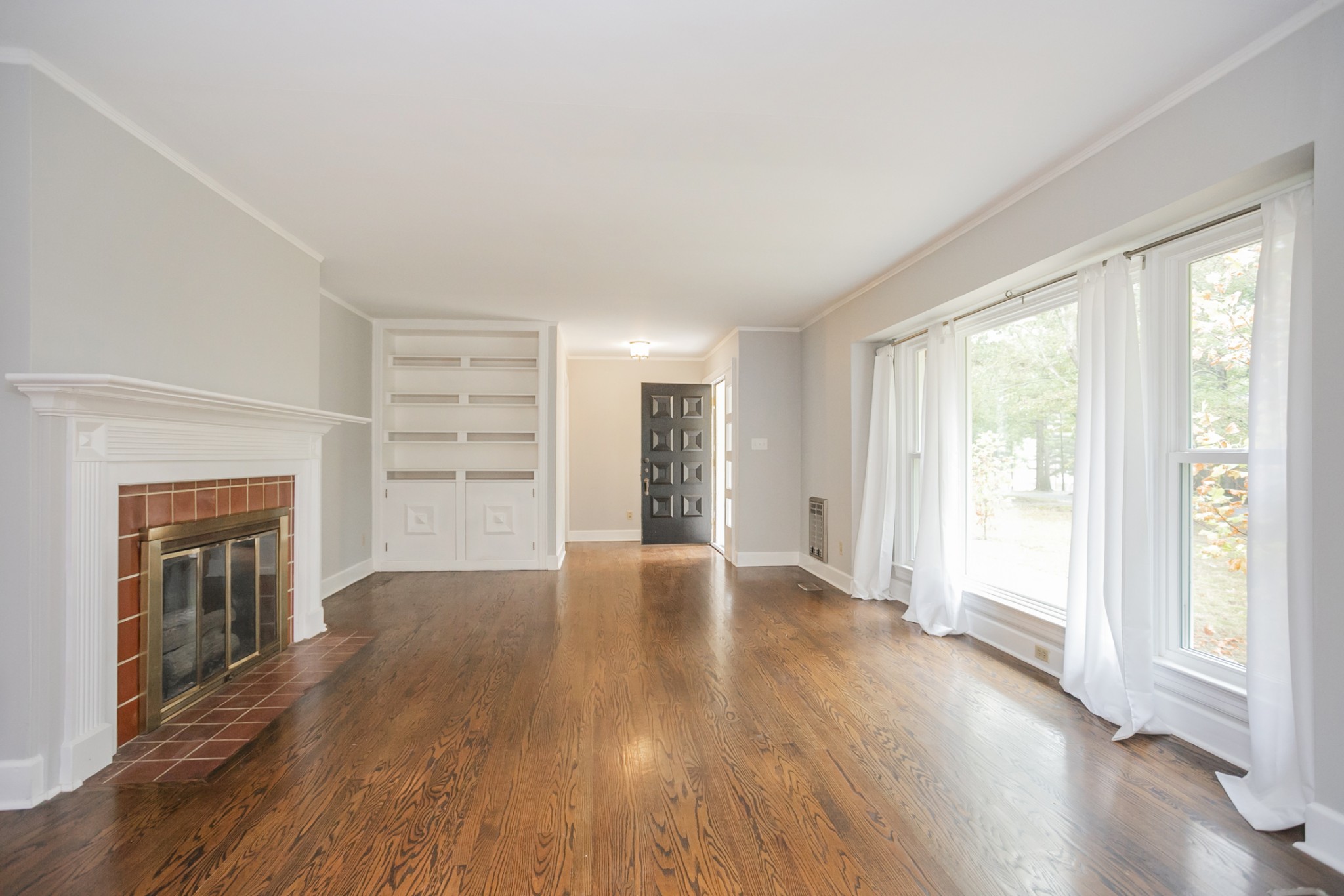 105 Echo Road Dickson, TN 37055 - Photo 3 of 32 an empty room with wooden floor fireplace and windows