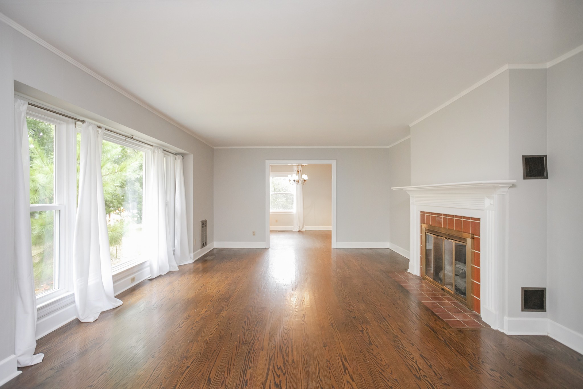 105 Echo Road Dickson, TN 37055 - Photo 4 of 32 a view of an empty room with wooden floor and a window